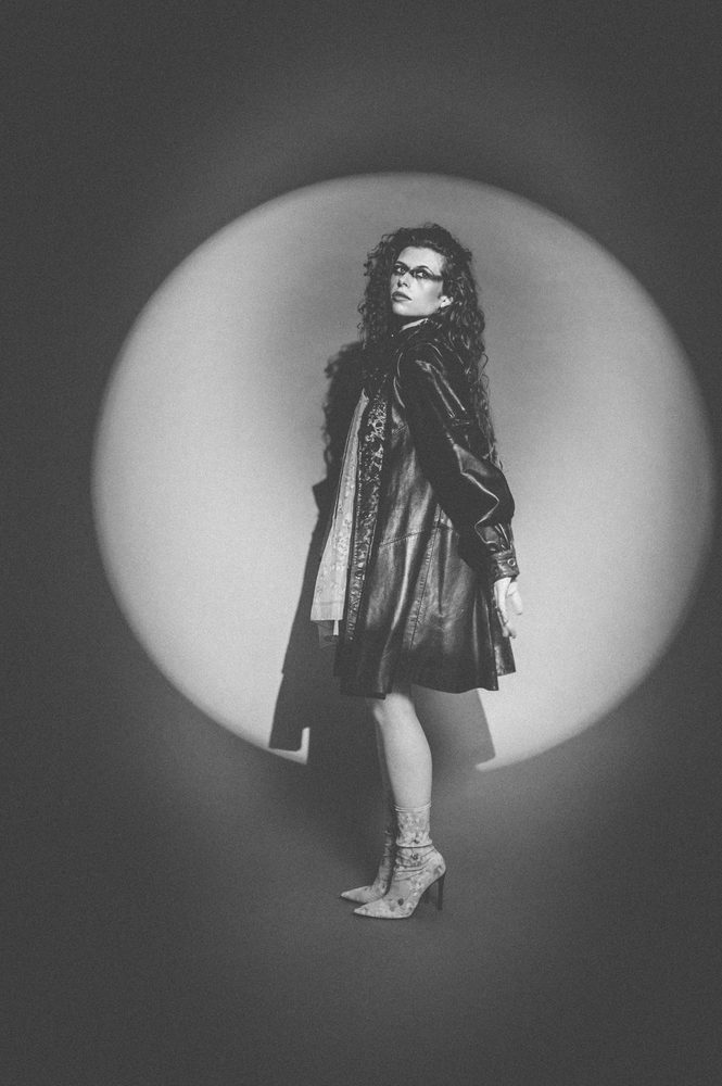 Hannah Wicklund in a spotlight, black and white
